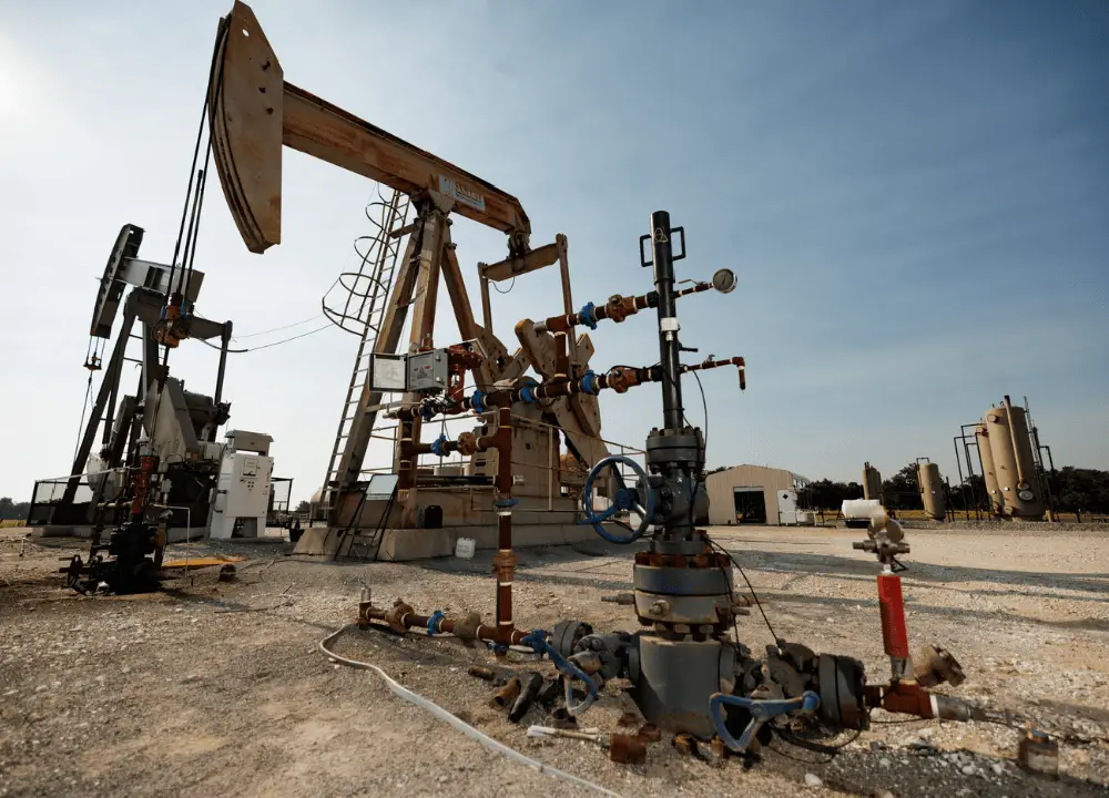 Oilfield landscape with pump jacks at sunset or a general oil & gas production site.