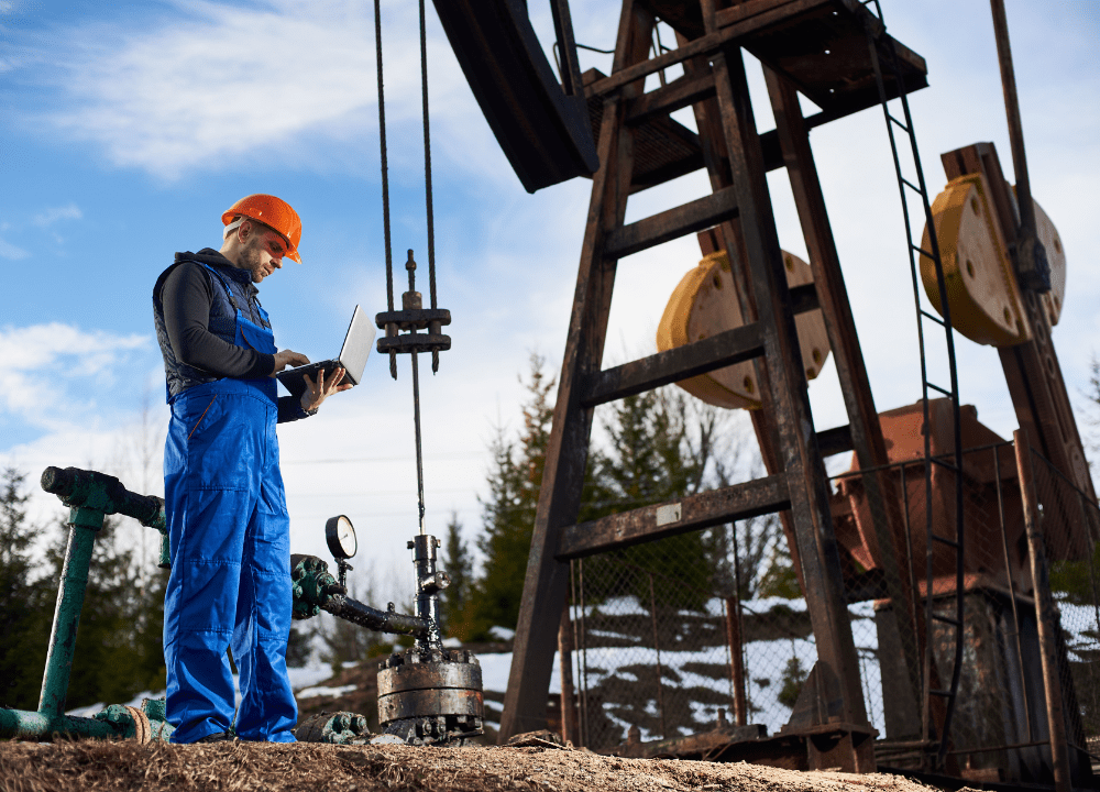 Mature oilfield site with storage tanks and production equipment.