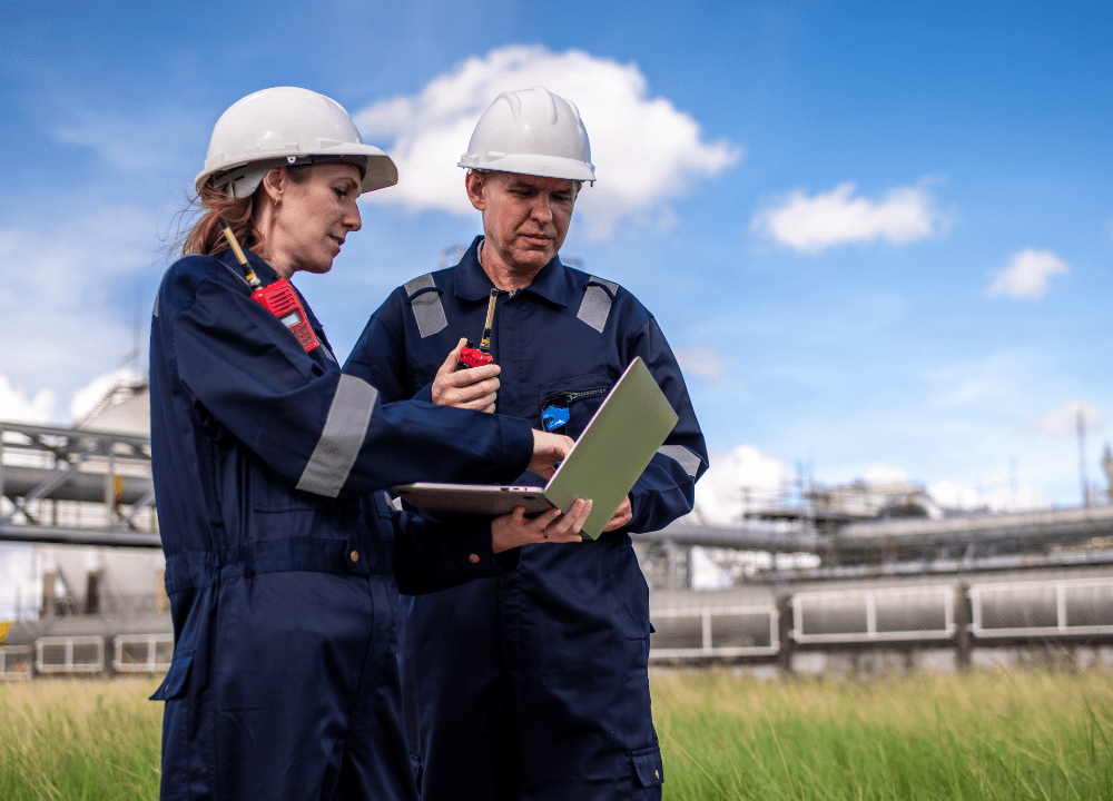 Technicians performing maintenance on plunger lift equipment.