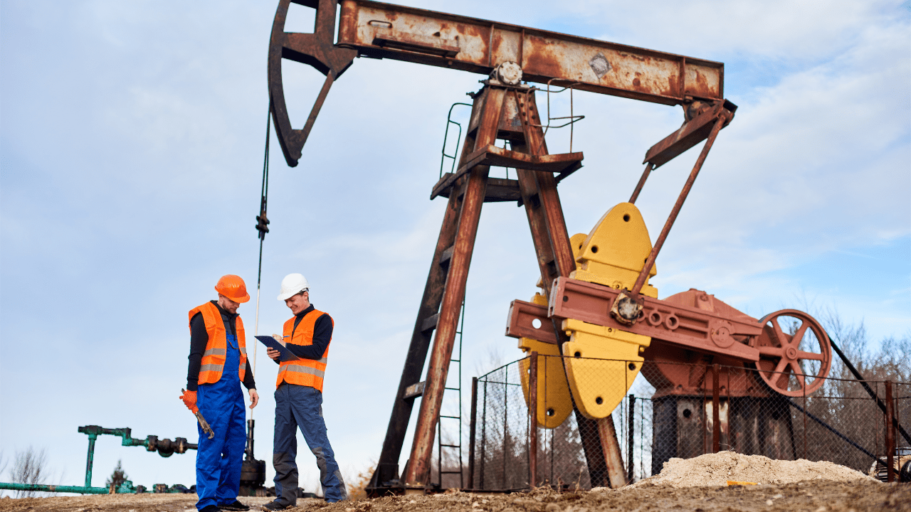 Oilfield engineers inspecting U.S.-made plunger tools at an oil production site