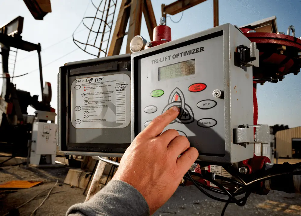 Worker recording data on a tablet during cycle time monitoring.